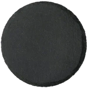 A dark gray to black circular disc with rough, textured surface and slightly irregular edges on white background
